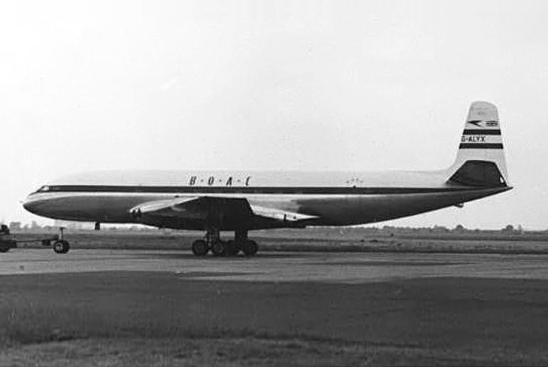 A black and white photograph of an airplane on a runway.